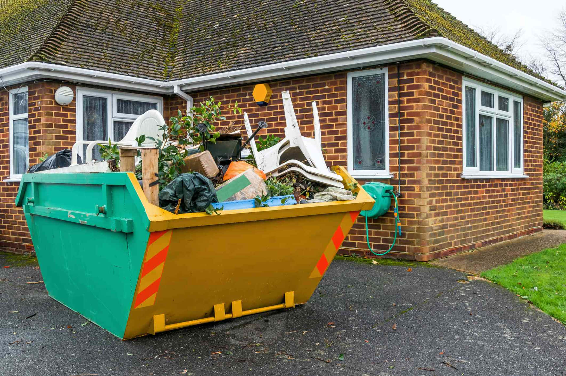 Skip bins in house backyard